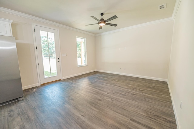 unfurnished room featuring visible vents, baseboards, dark wood finished floors, ceiling fan, and crown molding