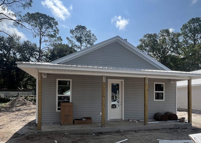 view of front facade with a porch and metal roof