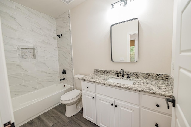 full bathroom with toilet, tub / shower combination, wood finished floors, and vanity