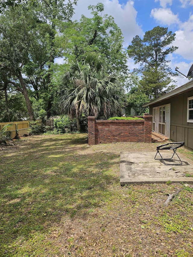view of yard with fence and a patio