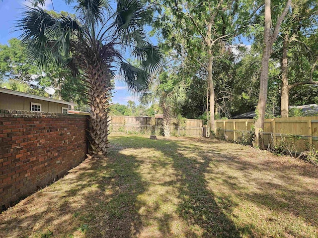view of yard with a fenced backyard