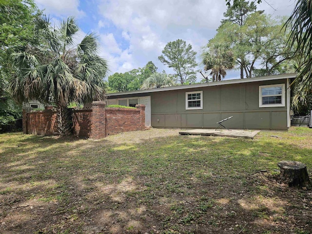 exterior space featuring fence and a lawn