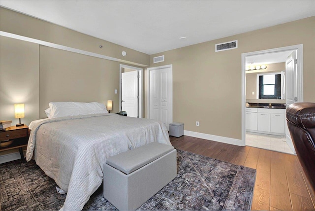 300 S Duval St Unit 1402, Tallahassee, FL 32301 - bedroom with light wood finished floors, baseboards, ensuite bathroom, and visible vents