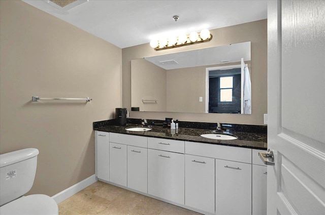 300 S Duval St Unit 1402, Tallahassee, FL 32301 - full bathroom with toilet, a sink, double vanity, and baseboards