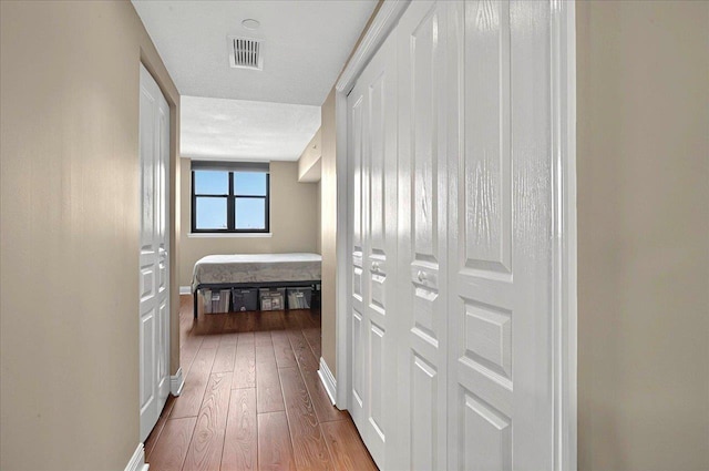 300 S Duval St Unit 1402, Tallahassee, FL 32301 - hall featuring hardwood / wood-style floors, visible vents, and baseboards