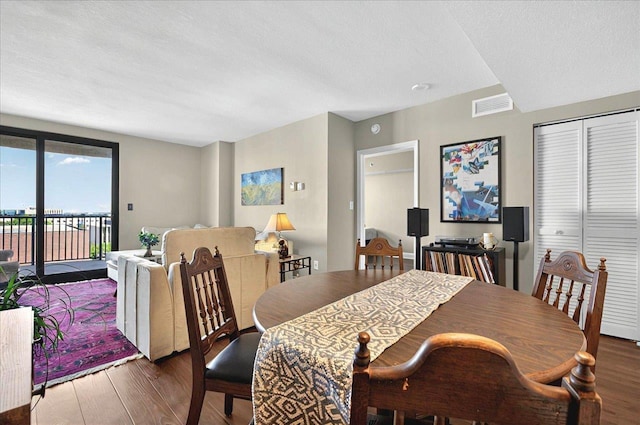 300 S Duval St Unit 1402, Tallahassee, FL 32301 - dining room with a textured ceiling, wood finished floors, and visible vents