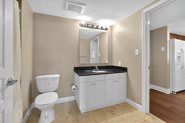 300 S Duval St Unit 1402, Tallahassee, FL 32301 - bathroom with baseboards, visible vents, vanity, and toilet