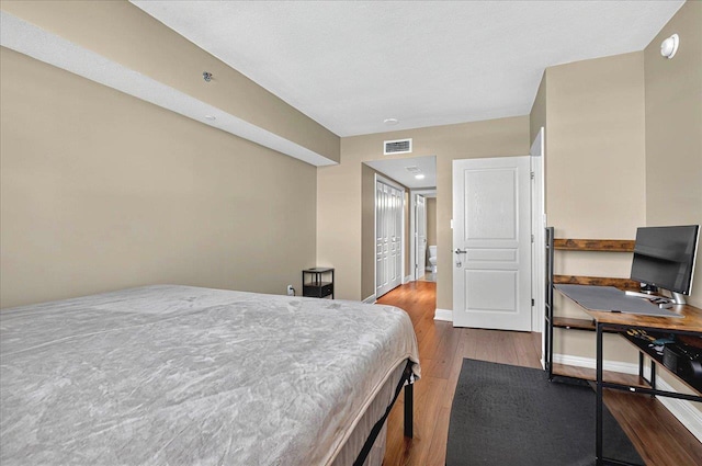 300 S Duval St Unit 1402, Tallahassee, FL 32301 - bedroom with baseboards, wood finished floors, and visible vents