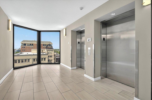 300 S Duval St Unit 1402, Tallahassee, FL 32301 - spare room featuring a wall of windows, elevator, and baseboards