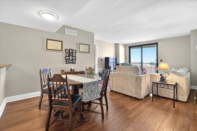 300 S Duval St Unit 1402, Tallahassee, FL 32301 - dining area featuring wood finished floors and a textured ceiling