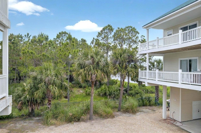 view of yard featuring a balcony and fence