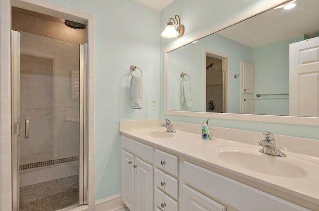bathroom featuring a shower stall and double vanity