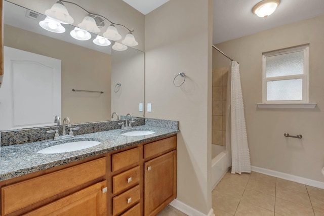 full bath featuring double vanity, visible vents, a sink, and tile patterned floors