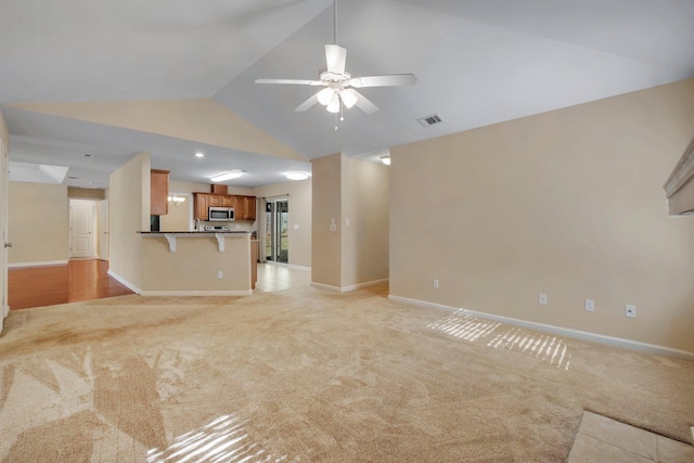 unfurnished living room featuring light carpet, baseboards, visible vents, and a ceiling fan