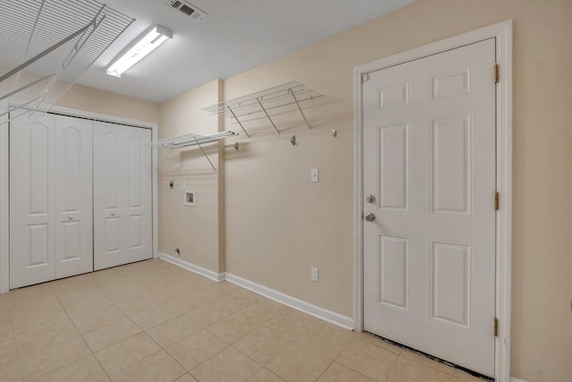 laundry area featuring laundry area, visible vents, baseboards, hookup for a washing machine, and light tile patterned flooring