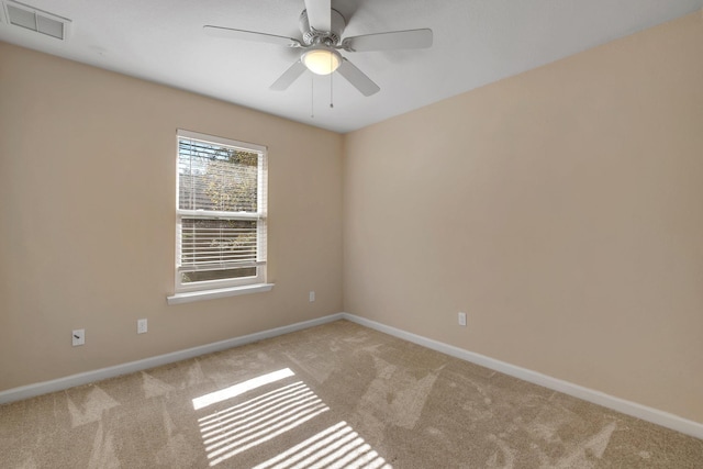 spare room featuring a ceiling fan, carpet, visible vents, and baseboards