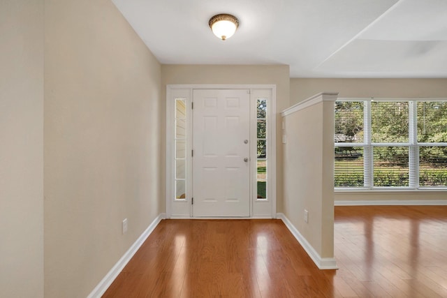 entrance foyer featuring hardwood / wood-style flooring and baseboards