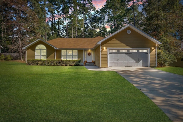 ranch-style home with driveway, a front lawn, and an attached garage