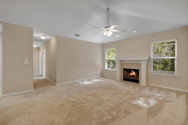 unfurnished living room featuring light carpet, baseboards, visible vents, lofted ceiling, and a fireplace