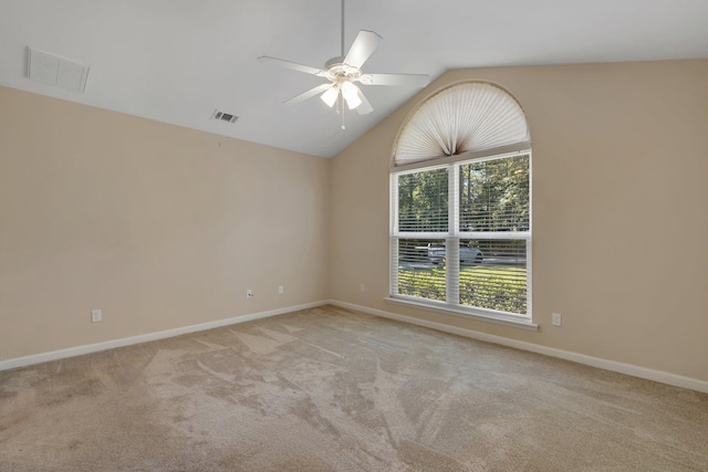 carpeted empty room featuring vaulted ceiling, visible vents, and baseboards