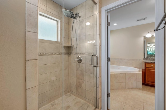 bathroom featuring a garden tub, visible vents, a shower stall, vanity, and tile patterned flooring