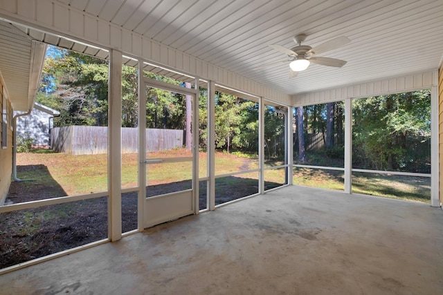 unfurnished sunroom featuring a ceiling fan