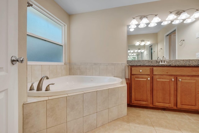 full bathroom with vanity, a bath, and tile patterned floors