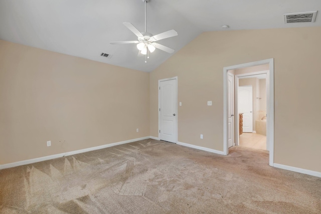 unfurnished bedroom with carpet, visible vents, vaulted ceiling, and baseboards