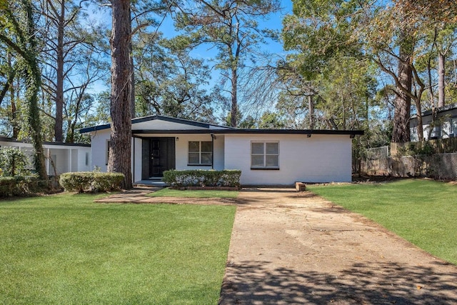 ranch-style home featuring a front yard