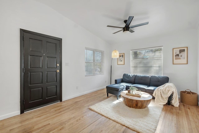 living room featuring wood-type flooring, lofted ceiling, and ceiling fan