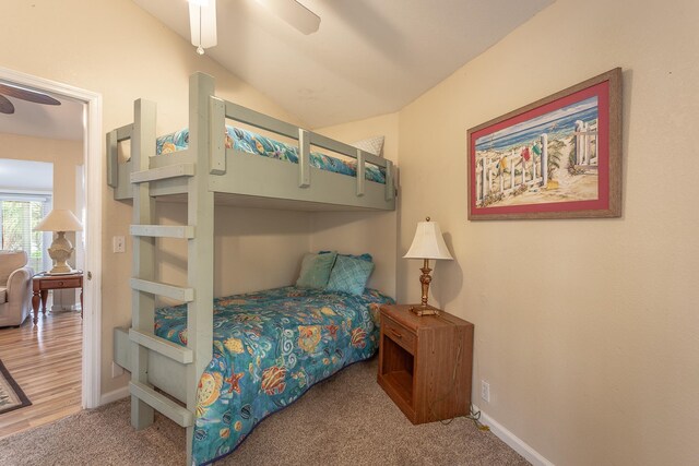 bedroom with lofted ceiling, hardwood / wood-style floors, and ceiling fan