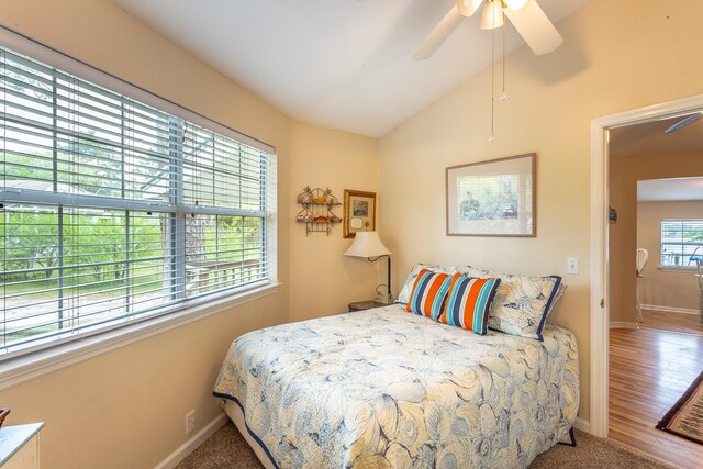 bedroom with hardwood / wood-style floors, lofted ceiling, and ceiling fan