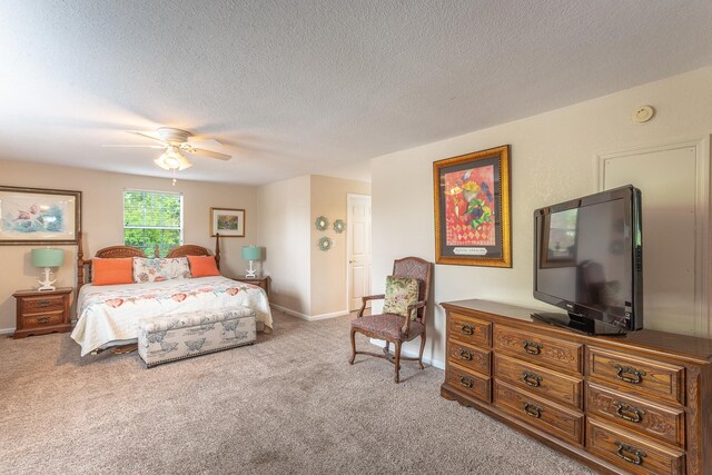 bedroom with a textured ceiling, light carpet, and ceiling fan