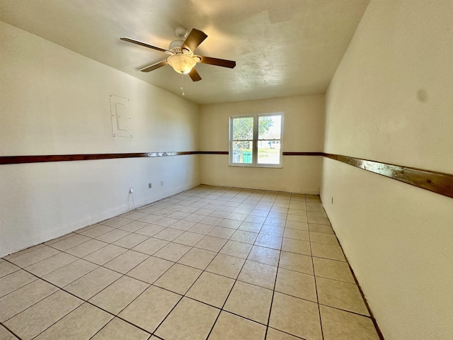 unfurnished room with ceiling fan and light tile patterned floors