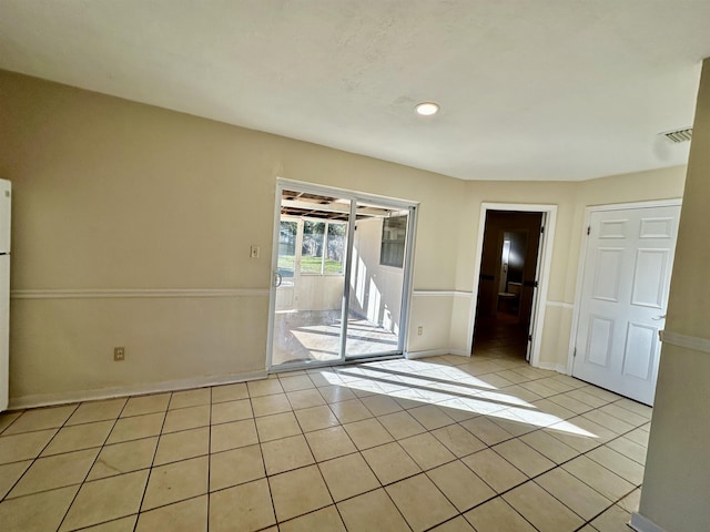 spare room with light tile patterned floors