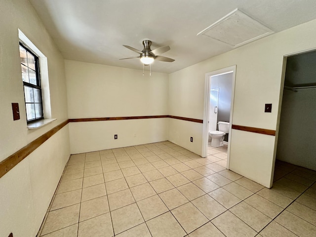 empty room with light tile patterned floors and ceiling fan