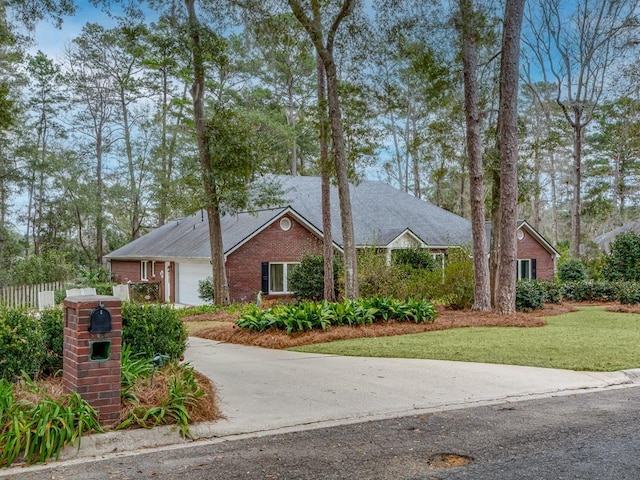 ranch-style home with a garage and a front yard