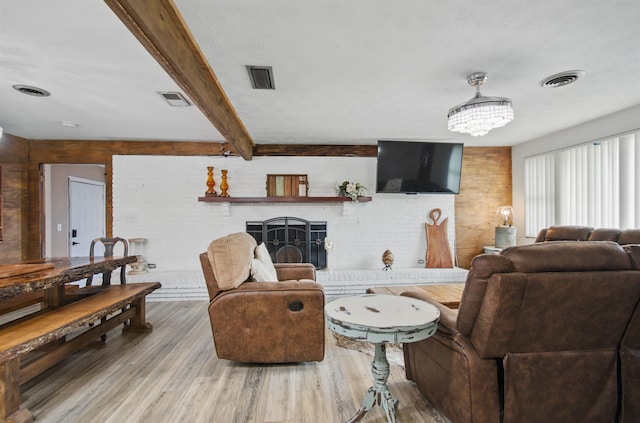 319 Glenridge Rd, Perry, FL 32348 - living area featuring a fireplace, wood finished floors, a chandelier, and beam ceiling