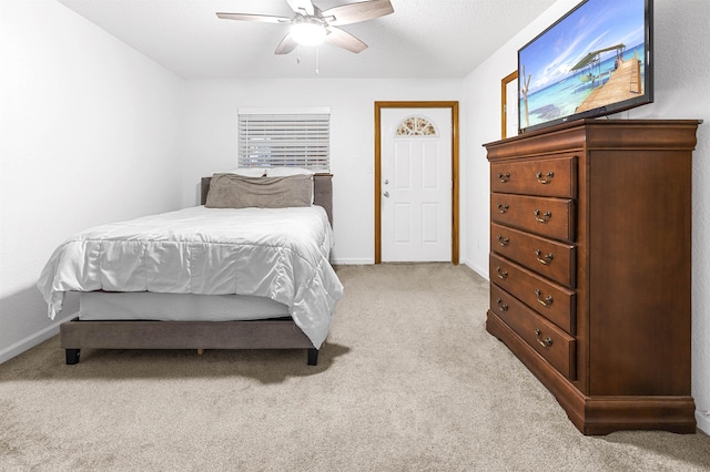 bedroom featuring ceiling fan and light carpet