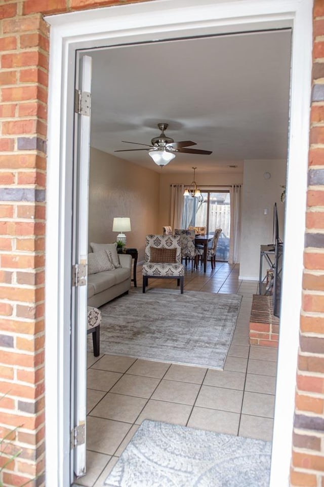 tiled living room featuring ceiling fan