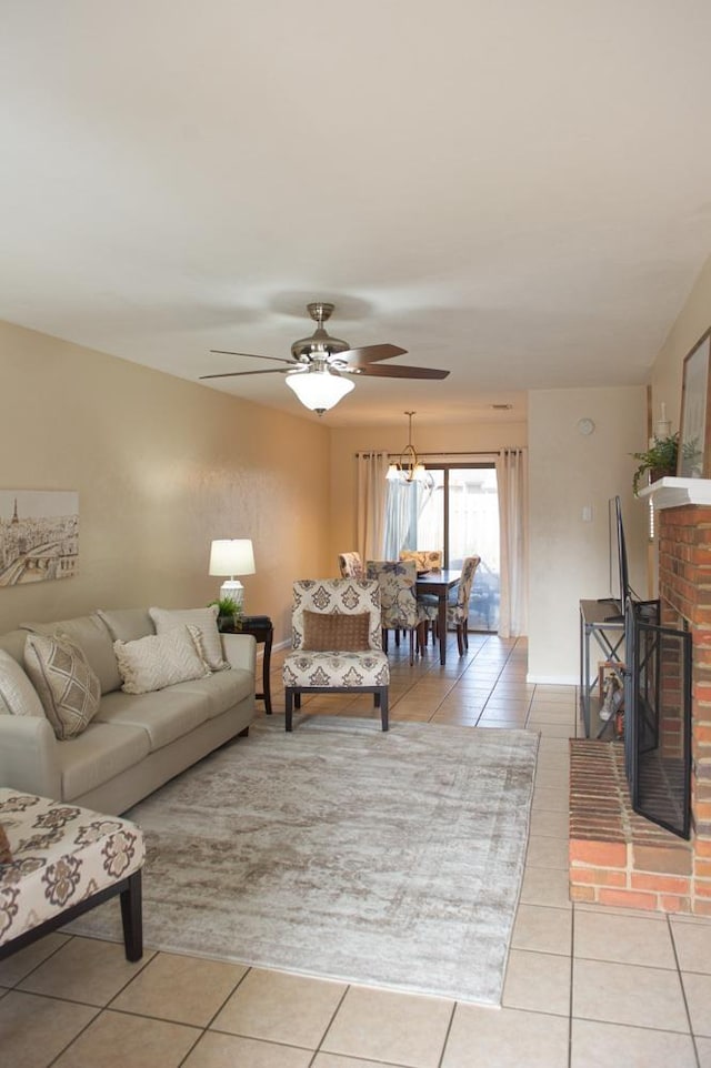 tiled living room with ceiling fan and a fireplace