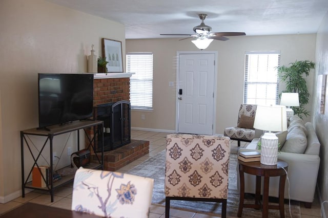 living room with a fireplace, ceiling fan, and light tile patterned flooring