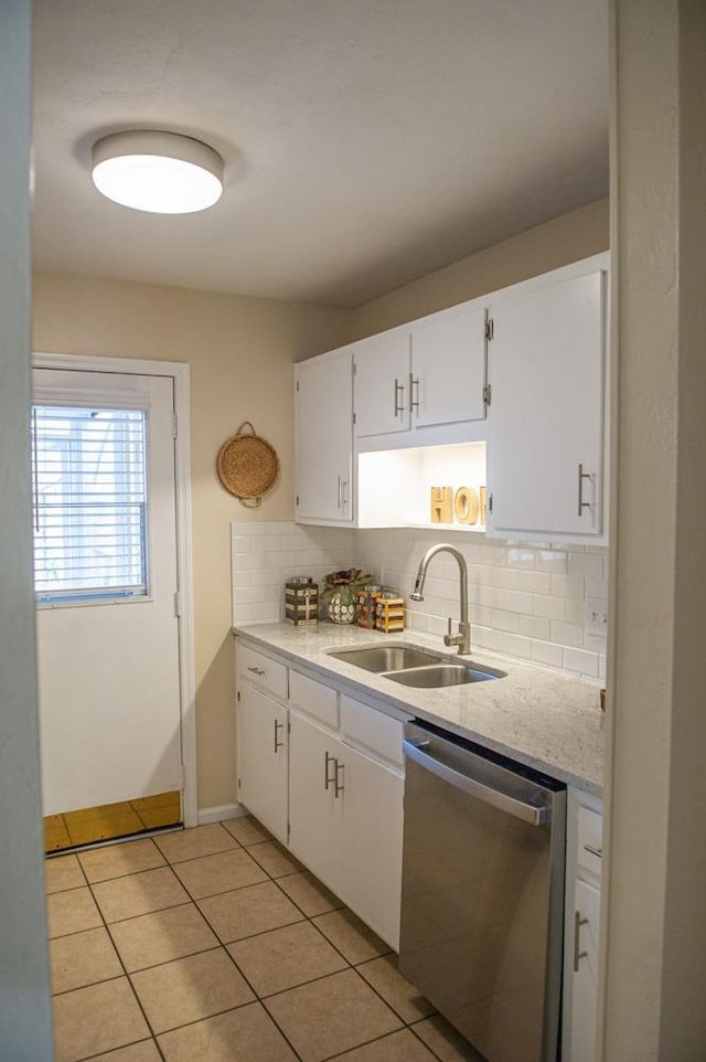 kitchen with stainless steel dishwasher, sink, decorative backsplash, and white cabinets