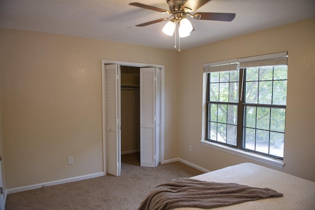 bedroom with multiple windows, carpet flooring, ceiling fan, and a closet