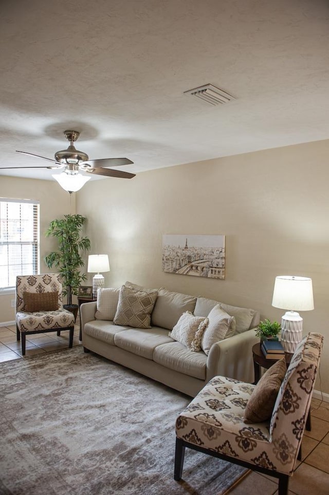 living room featuring light tile patterned floors and ceiling fan