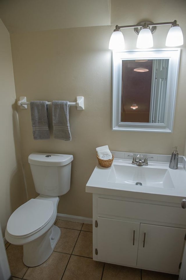 bathroom featuring tile patterned floors, toilet, and vanity