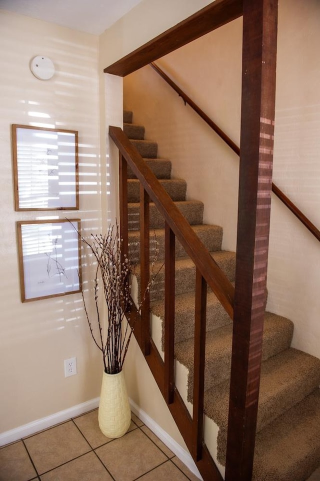 stairway with tile patterned flooring