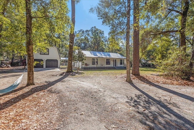 view of front of home featuring a porch and a garage