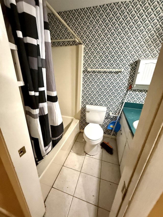 full bathroom featuring shower / bath combo, toilet, tile patterned floors, vanity, and tile walls