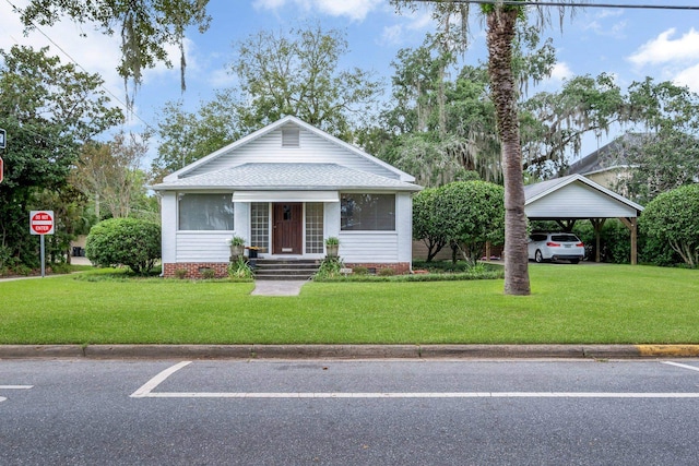 view of front of property with a carport and a front yard